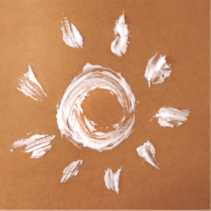 Tan skin and tanning solution in the shape of a sun | Sol Potion Sunless Tanning | Best Spray Tan Solutions and Skincare